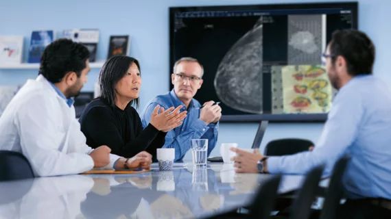A diverse enterprise team collaborates in a modern boardroom meeting.