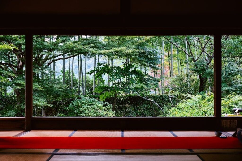 Tatami room with a wide window overlooking a lush garden