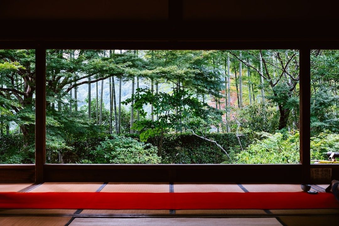 Tatami room with a wide window overlooking a lush garden